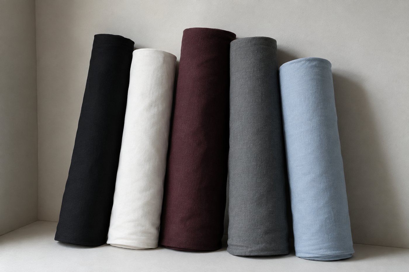 Bolts of fabric leaning against a wall