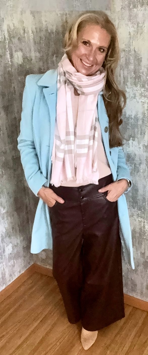 Heather in a pale aqua coat and a blush scarf, from her own wardrobe