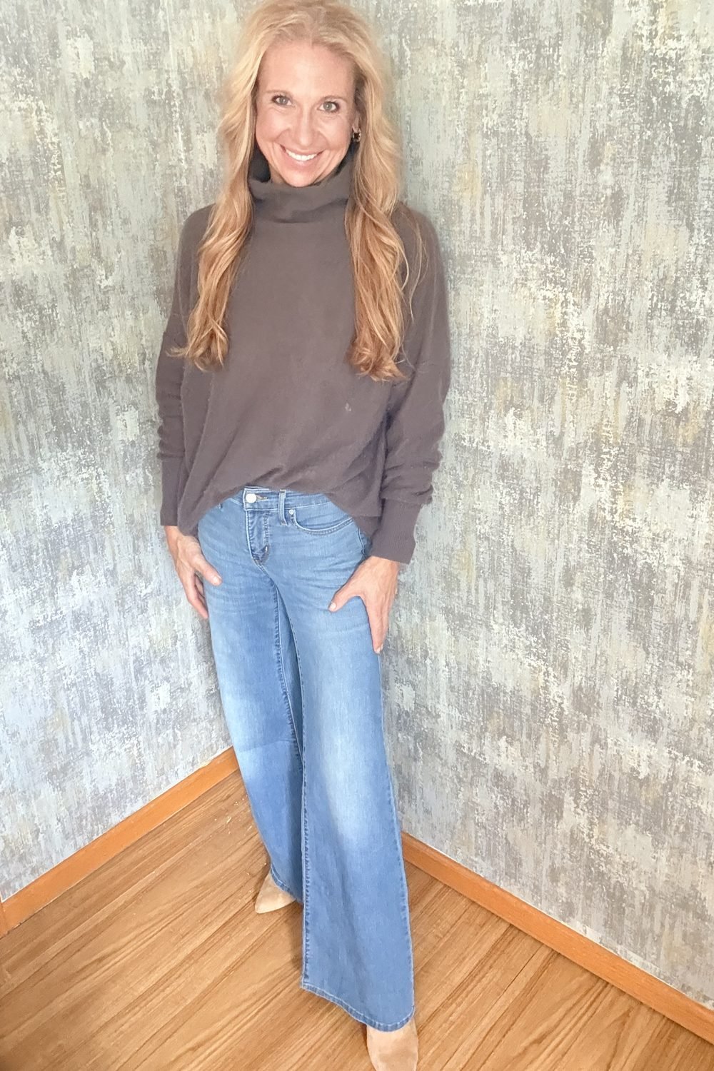 A Smoky Mauve turtleneck worn with light wide-leg jeans