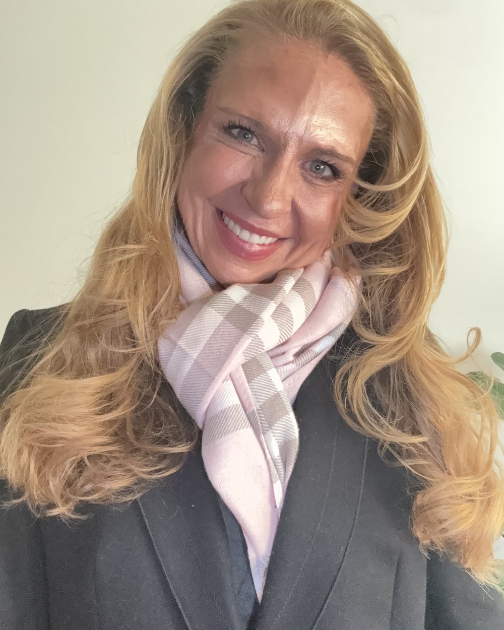 The same black coat with a soft pink plaid scarf at Heather’s neck