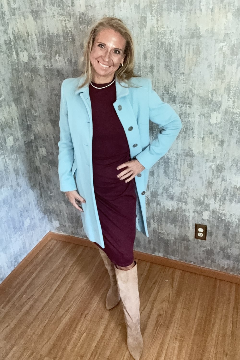 Heather in the same powder blue coat over a wine knit dress and tall suede boots